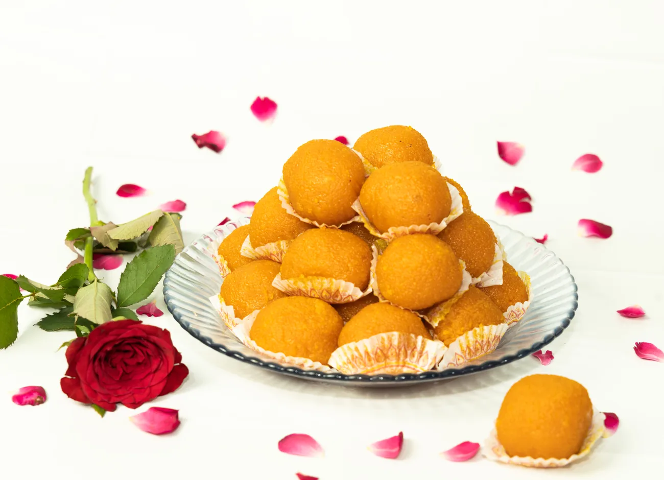Motichoor laddu pyramid with rose petals — our photo Motichoor laddu pyramid with rose petals — our photo
