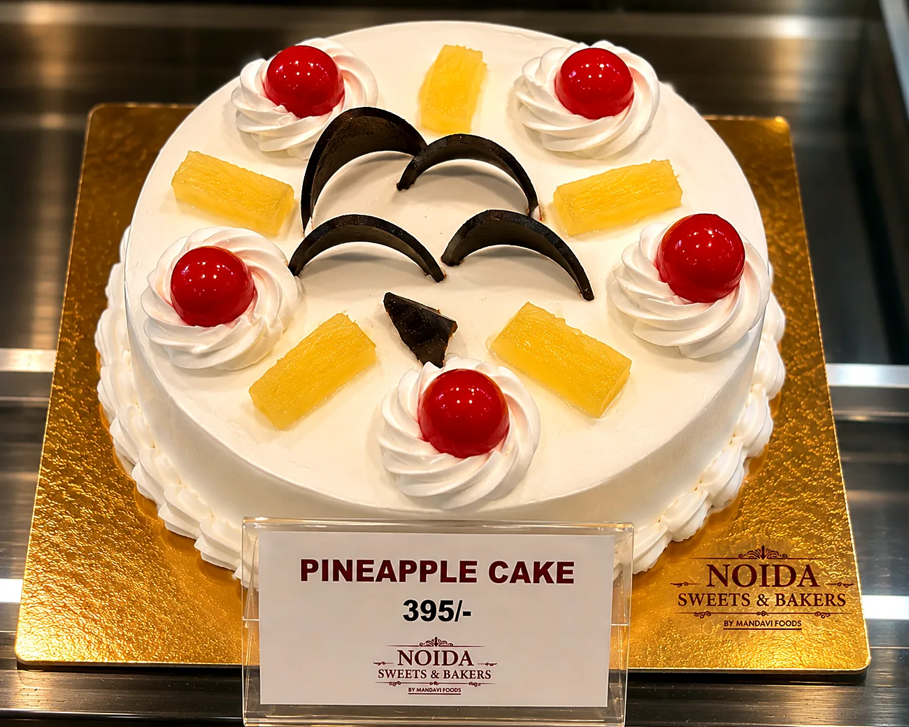 Pineapple cake — our photo Pineapple cream cake with fresh fruit crown — made at Noida Sweets and Bakers