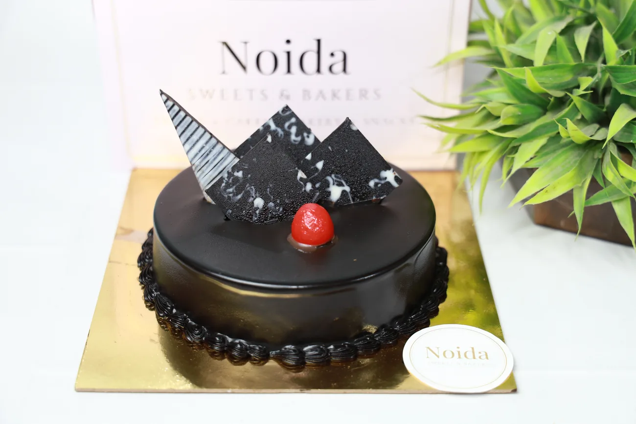 Truffle cake — our photo Truffle cake with chocolate shards and cherry — made at Noida Sweets and Bakers